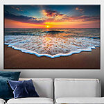 Obraz Fale zachodzącego słońca obejmują brzeg